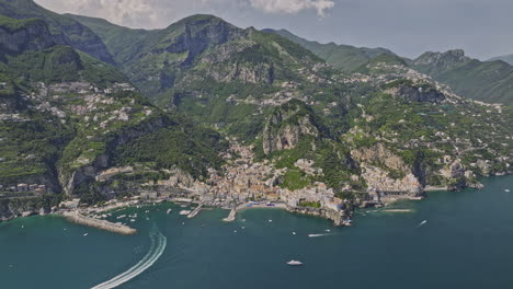 Amalfi-Italy-Aerial-v10-drone-flyover-Tyrrhenian-sea-capturing-harbor,-cliffside-and-hillside-neighborhood,-town-center,-mountainous-terrain-and-verdant-valleys---Shot-with-Mavic-3-Cine---May-2023