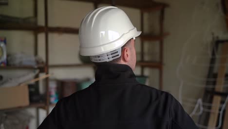 Male-Architect-In-White-Hard-Hat-Checking-Out-Residential-Space-For-Renovation