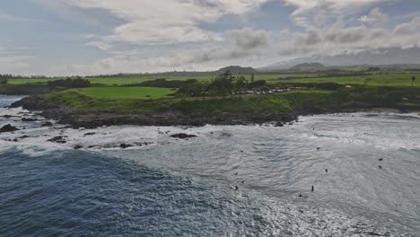 Maui-Hawaii-Aerial-v34-flyover-Ho'okipa-lookout-capturing-white-sandy-beach-park-with-waves-crashing-the-rocky-shoreline-and-beautiful-pacific-ocean-views---Shot-with-Mavic-3-Cine---December-2022