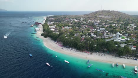 Aerial-over-Gili-Trawangan-East-Beach,-nestled-in-Indonesia,-is-a-slice-of-tropical-heaven-that-beckons-travelers-with-its-tranquil-beauty-and-serene-charm