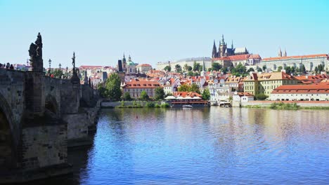 Charles-Bridge-towards-the-small-town-where-you-can-see-the-Prague-Castle-in-the-Czech-Republic,-sunny-day