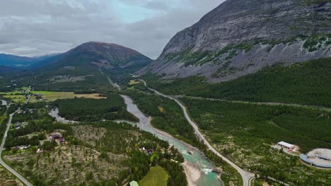 Aerial-along-the-river-and-road-near-Donnfossen,-Nordberg,-Norway