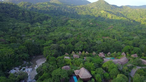 Cabin-cottage-resort-in-the-middle-of-the-lush-tropical-jungle-at-sunset