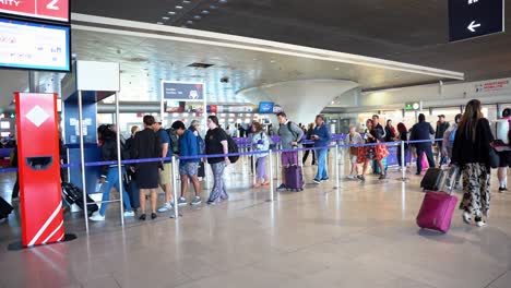 Large-line-of-people-with-the-right-of-way-granted-by-a-cabin-crew-member-in-the-boarding-area-to-pass-through-with-their-passage,-Paris-airport,-France