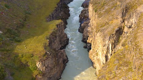 Aerial-view-captures-majesty-of-Gullfoss-Falls,-showcasing-both-nature's-power-and-mesmerizing-water-flow