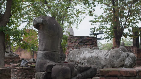 Broken-of-Buddha-statue-without-head-in-forest-at-Wat-Umong-Chiang-Mai