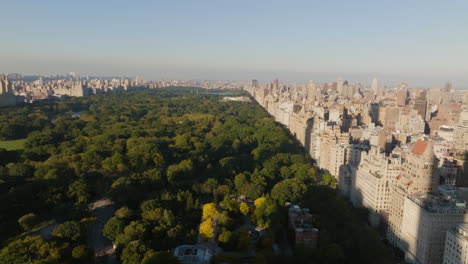 Drone-shot-tilting-over-the-Central-park,-autumn-golden-hour-in-Manhattan,-NYC