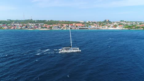 Drone-side-to-side-tracking-follow-of-catamaran-motoring-sails-down-off-Caribbean-Coast
