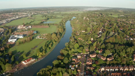 Aerial-shot-over-river-passing-through-residential-area-UK