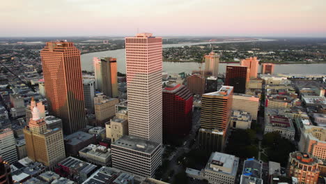 Panoramic-drone-shot-of-downtown-New-Orleans,-sunny-evening-in-Louisiana,-USA
