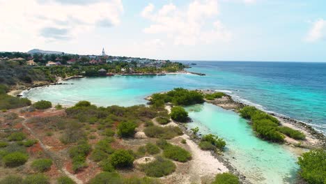 Sweeping-panoramic-aerial-overview-of-coastal-desert-by-Zanzibar-beach,-Jan-Thiel-Curacao