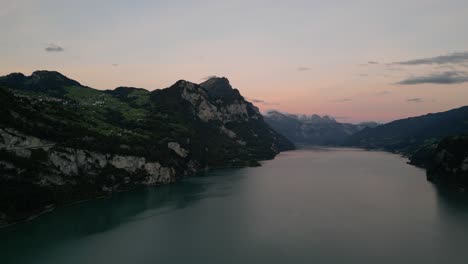 Drone-flight-over-the-lake-with-mountain-and-beautiful-sky-near-Walensee-lake,-Switzerland