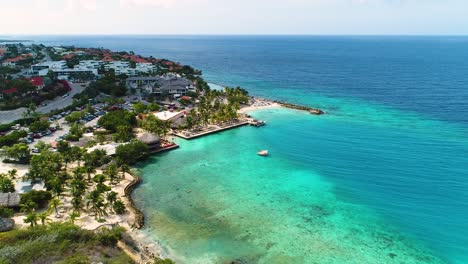 Sandy-coral-reef-and-turquoise-blue-Caribbean-ocean-waters-of-Zanzibar-beach,-Jan-Thiel-Curacao