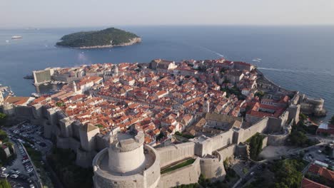 Northwest-aerial-reveal:-Dubrovnik-Old-Town,-historic-walls,-Adriatic-Sea,-and-Croatian-island