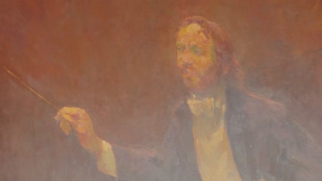 Close-up-of-impressionistic-painting-of-conductor-holding-baton