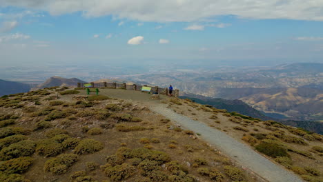 Drone-Flying-Towards-Hiker-At-Observation-Deck-In-Sierra-de-las-Nieves-National-Park,-Andalusia,-Spain