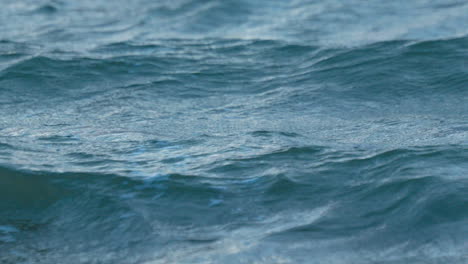 A-close-up-view-in-4K-of-calm-blue-ocean-waves-for-tranquility-and-relaxation
