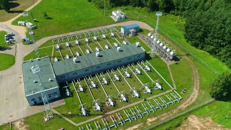 Aerial-view-circling-a-natural-gas-pumping-station-on-the-sunny-countryside