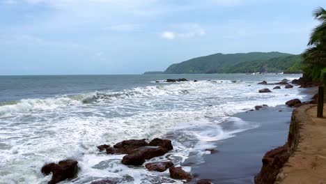 Sea-waves-hitting-rocks-on-a-sunny-day-Cola-Beach-Goa-India-4K