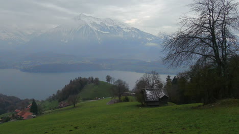 Cinematic-aerial-drone-beautiful-Swiss-Alps-Pyramid-Peak-countryside-dancing-in-the-fog-hillside-sounds-of-music-scene-Thun-Bern-Interlocken-Switzerland-mountainside-down-jib-movement