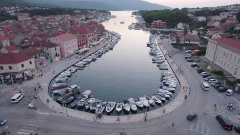 Aerial:-Stari-Grad-harbor,-Hvar-Island,-Croatia---historic-buildings-and-moored-boats