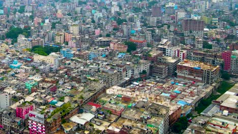 Drone-Fly-Over-Dhaka-Cityscape-Along-Buriganga-Riverbanks-In-Bangladesh
