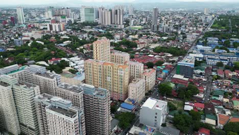 Rising-drone-shot-over-residential-high-rises-in-Quezon-City,-Philippines