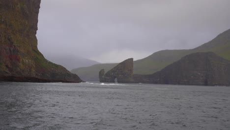 Boat-sailing-through-the-North-Atlantic-Ocean-heading-towards-Drangarnir-sea-stacks-arch