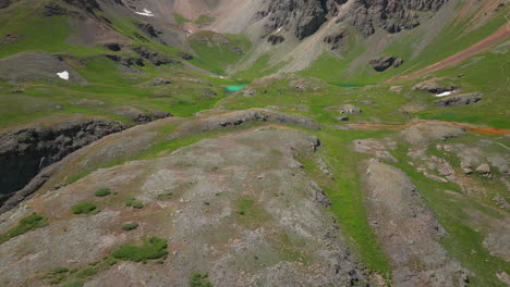 Aerial-drone-cinematic-zoom-close-Ice-Lake-Basin-trail-hike-Silverton-Island-Lake-Ouray-Red-Mountain-Pass-Colorado-dreamy-heavenly-Rocky-mountain-scene-summer-snow-melting-Rocky-peaks-forward-reveal