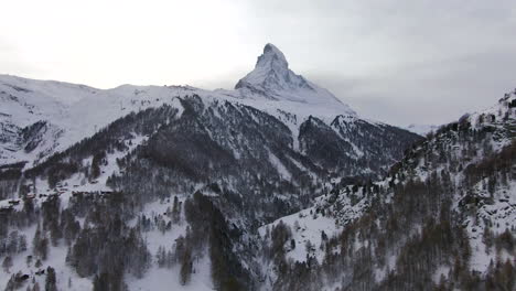 Die-Matterhorn-Luftkino-Drohne,-Atemberaubende-Winterliche-Eröffnungsszene,-Zermatt,-Schweiz,-Schweizer-Alpen,-Berühmtester-Berggipfel,-Anfang-Oktober,-Starker-Neuschneefall,-Sonnenuntergang,-Aufwärtsbewegung
