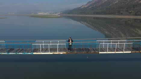 Drone-view-of-man-standing-on-a-bridge-in-Kardjali-,Bulgaria