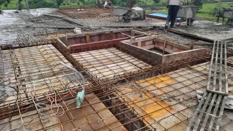 Building-workers-are-constructing-a-metal-framework-and-pouring-concrete-on-the-slab-at-construction-in-India