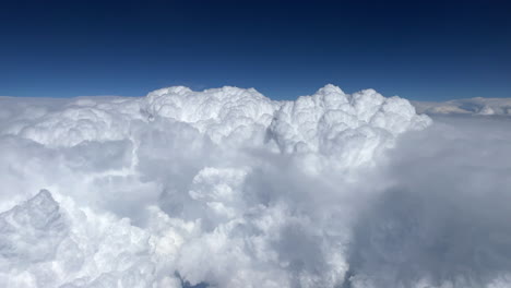 Large-white-cumulonimbus-clouds-on-a-sunny-day-seen-from-a-pilot-in-an-airplane