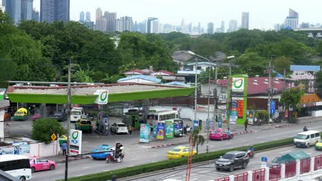 Bangchak-Petrol-Station-with-workers-filling-up-the-tanks-or-cylinders-as-seen-from-a-higher-viewpoint-in-Bangkok-while-the-motorists-are-passing-by-on-each-side-of-the-busy-city-road