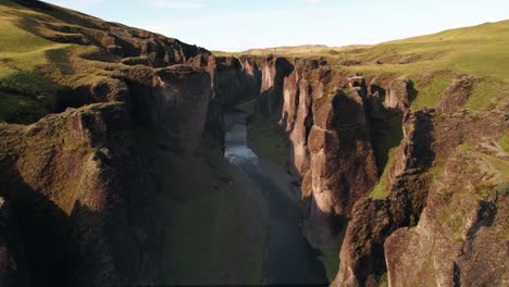 Aerial:-Reverse-reveal-of-the-Fjadrargljufur-winding-river-canyon-in-southern-Iceland-off-the-ring-road