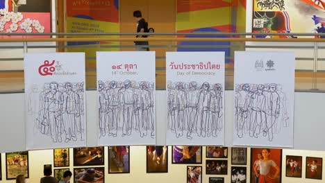 Spectators-walking-around-and-looking-at-the-various-artworks-displayed-on-the-different-floors-of-Bangkok-Arts-and-Culture-Centre-in-Pathum-Wan-District,-Bangkok,-Thailand