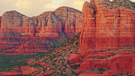 Telephoto-trucking-pan-across-desert-alpenglow-on-weathered-red-rock-canyon-in-the-southwest