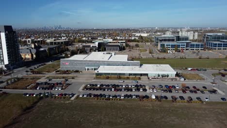 Drone-shot-of-the-YMCA-sports-facility-in-Quarry-Park-community-in-Calgary,-on-a-beautiful-sunny-day
