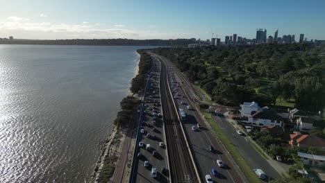 Drone-flyover-highway-with-traffic-in-Perth-City-during-sunset-time