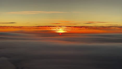 Spectacular-sunset-as-seen-by-the-pilots-in-a-real-flight-over-a-layer-of-clouds-at-1000m-high
