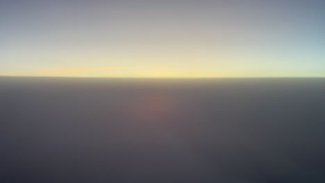 Awesome-sunset-as-seen-by-the-pilots-of-a-jet-flying-between-two-layers-of-clouds-with-an-intense-orange-color-sun