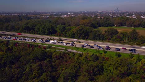 An-aerial-time-lapse-of-the-traffic-on-the-Belt-Parkway-and-the-shore-of-Jamaica-Bay-on-a-sunny-day-in-Brooklyn,-NY