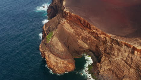 Aerial-drone-shot-of-majestic-red-colored-volcanic-coastline-in-the-Azores-Islands---Portugal