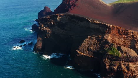 Flying-over-the-Capelinhos-red-rocky-coastline-n-the-Faial-island,-Azores---Portugal
