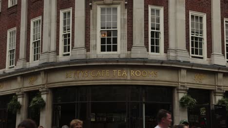 Hand-held-shot-of-the-gold-plated-Bettys-Cafe-Tea-Room-in-York-city-centre