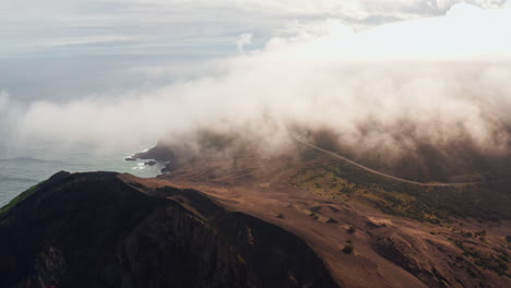 Cinematic-aerial-drone-shot-of-clouds-traveling-high-over-Capelinhos-Volcano-in-the-Faial-island-in-the-Azores---Portugal