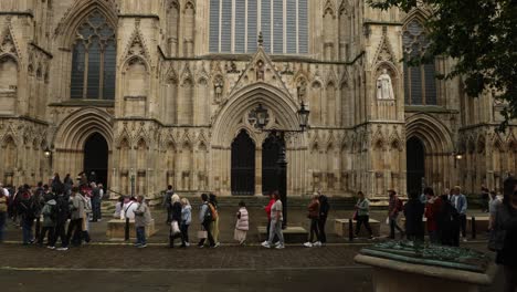 Hand-held-shot-of-tourists-queueing-in-front-of-York-Minster-waiting-to-enter