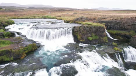 Aerial:-Reveal-Reykjafoss-waterfall-presents-itself-as-a-powerful-cascade-of-water