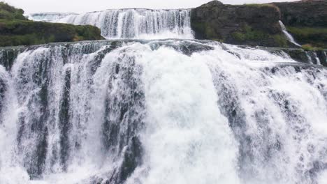 Aerial:-Slow-motion-Reykjafoss-waterfall-presents-itself-as-a-powerful-cascade-of-water