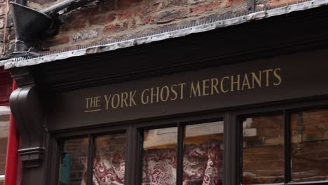 Close-up-shot-of-the-York-Ghost-Merchants-Storefront-in-the-Shambles,-York,-England